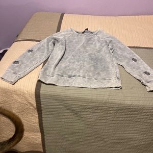 Women’s large sweatshirt with 2 metal grommets in each sleeve.